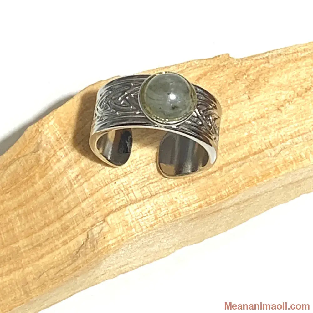 Bague réglable en acier inoxydable argenté avec pierre naturelle Labradorite, posée sur un bâton de Palo Santo.