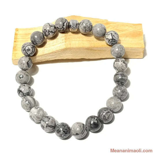Bracelet en perles de 10 mm Jaspe Picasso naturel posé sur bois de palo santo