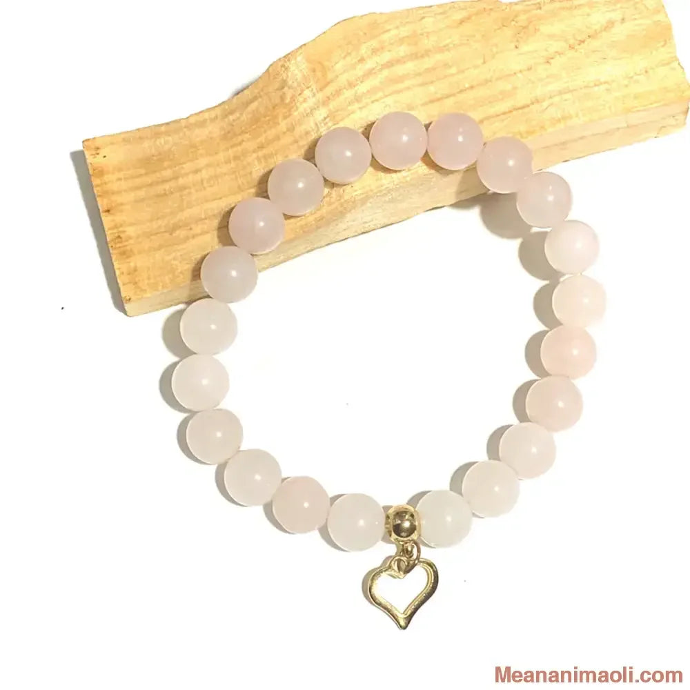 Bracelet quartz rose 8 mm en pierres naturelles pour lithothérapie avec breloque coeur en acier inox doré.