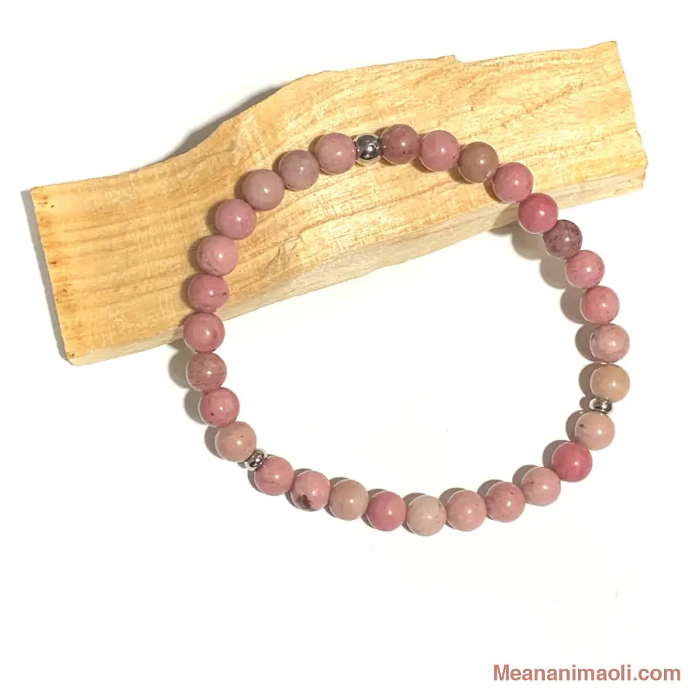 Bracelet en Rhodonite 6mm, perles acier inoxydable argenté posé sur un bâton de palo santo
